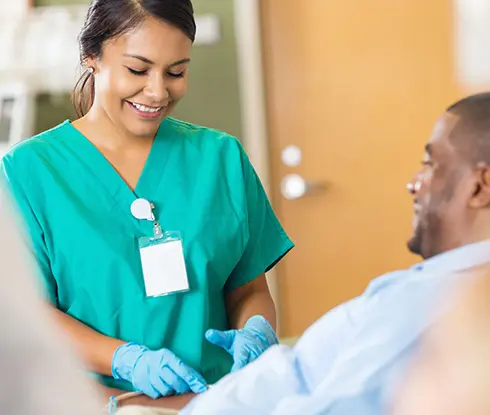 a women wearing scrub taking blood sample from male patient.